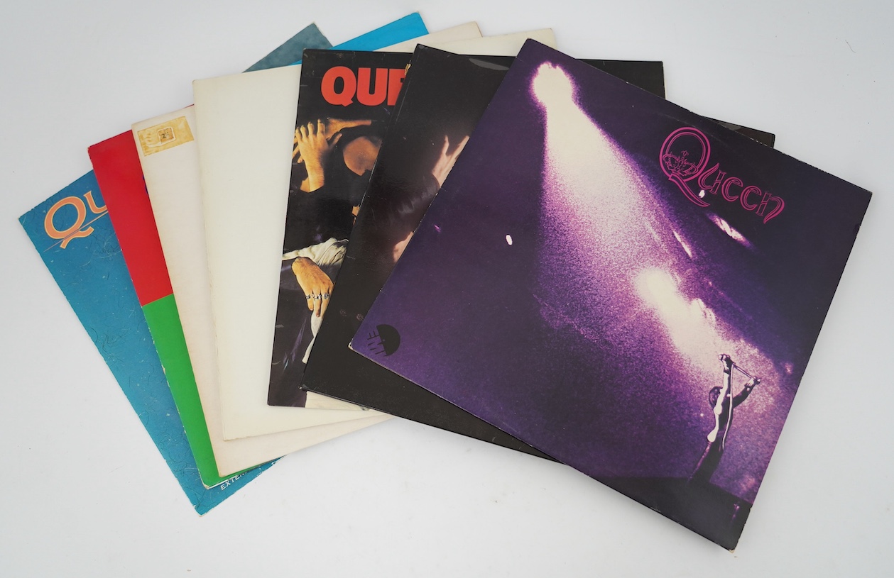 Seven Queen LP record albums and a 12” single; Queen, Queen II, Sheer Heart Attack, A Night at the Opera and another, Hot Space, The Game, and a 12” A Kind of Magic. Condition - fair to good